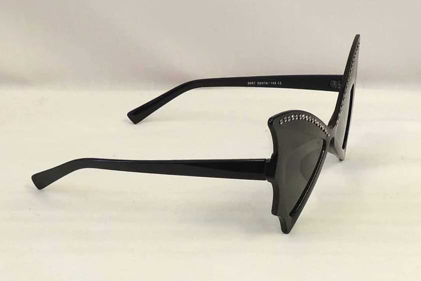 Side view of black butterfly wing sunglasses with sculpted frames and rhinestone accents along the top edge.